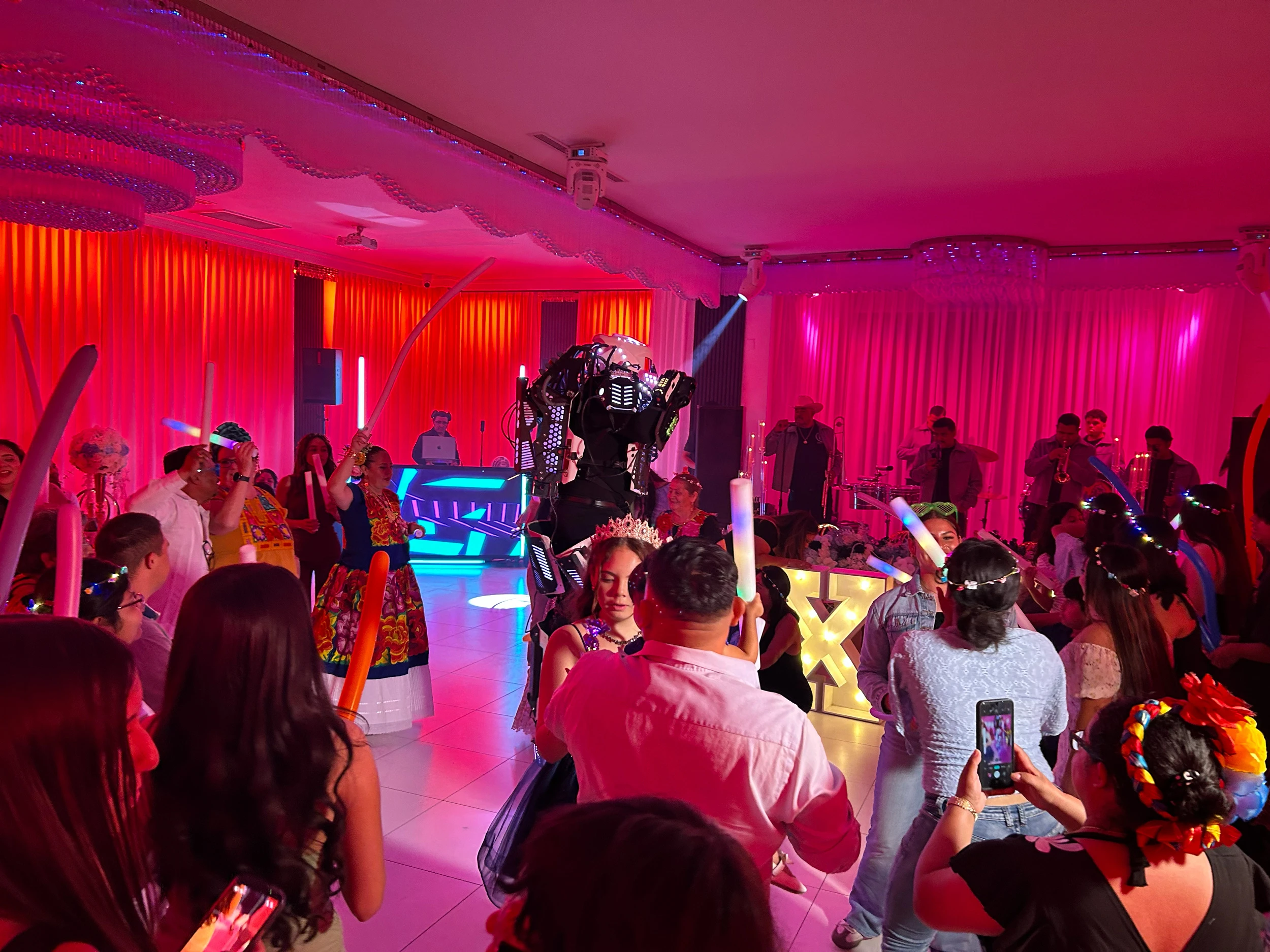 Illuminated robot performer dancing with guests at a Southern California event