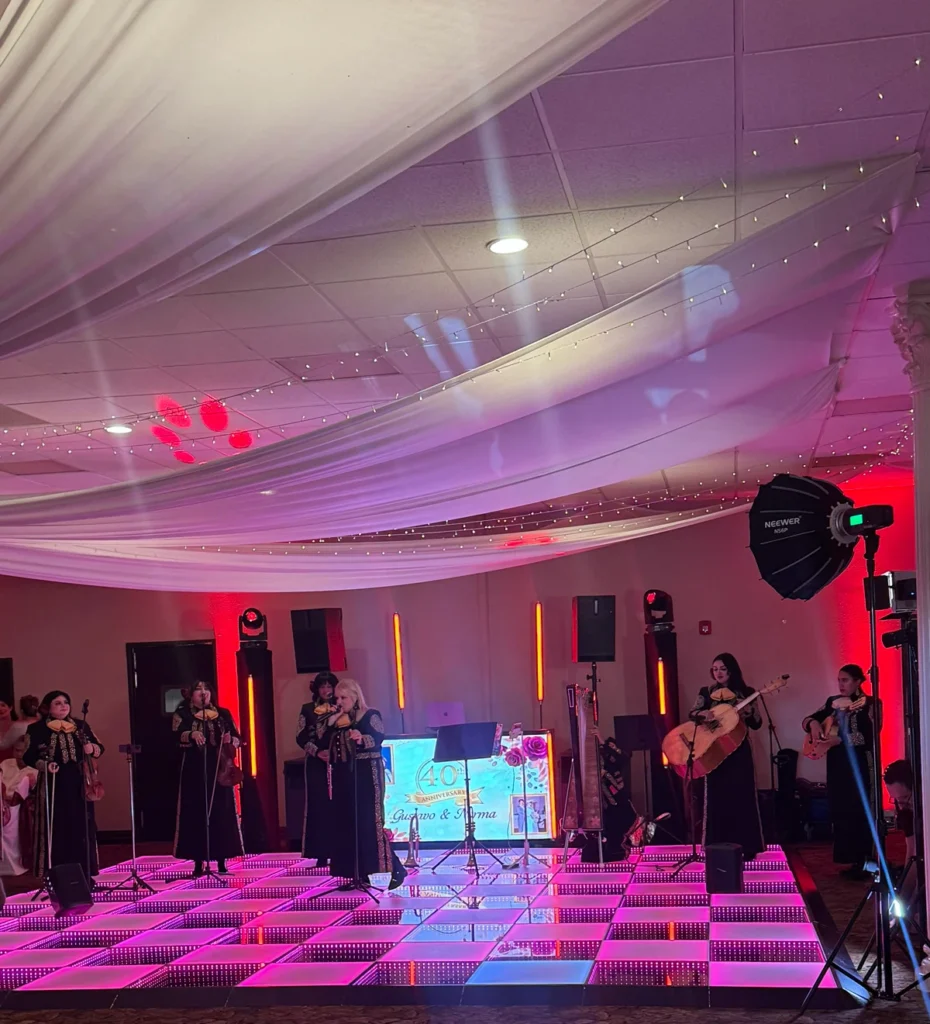 Mariachi band performing on an LED dance floor at a Los Angeles event