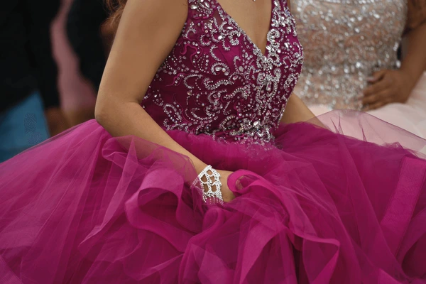 Detailed purple quinceañera ball gown with silver beadwork and layered tulle